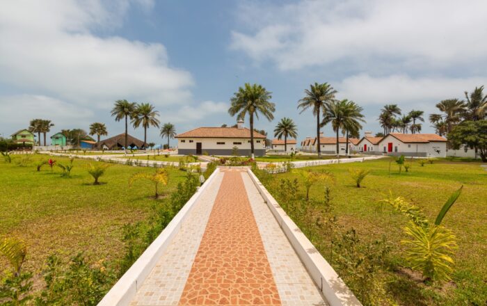 A beautiful pavement and the houses surrounded by grassy fields captured in Gambia, Africa