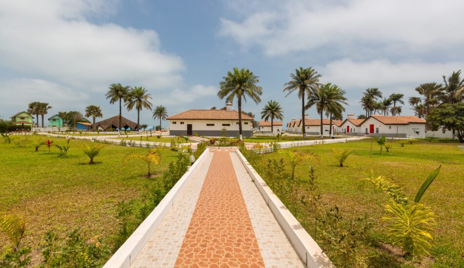A beautiful pavement and the houses surrounded by grassy fields captured in Gambia, Africa