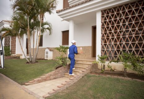long-shot-delivery-man-holding-box