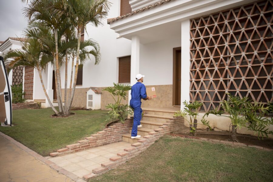 long-shot-delivery-man-holding-box